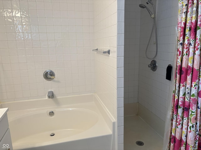 bathroom featuring a tile shower and vanity