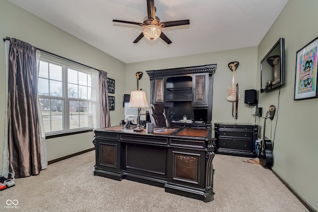 carpeted office featuring ceiling fan and baseboards