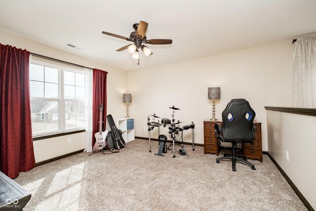 carpeted office with a ceiling fan, visible vents, and baseboards