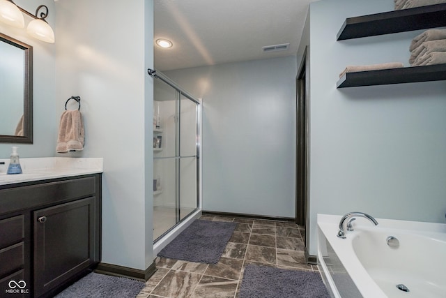 full bathroom with a garden tub, visible vents, a shower stall, vanity, and baseboards