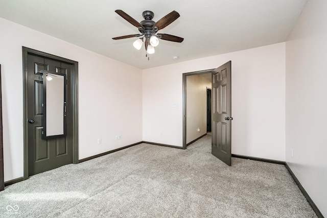 unfurnished bedroom with light carpet, ceiling fan, and baseboards