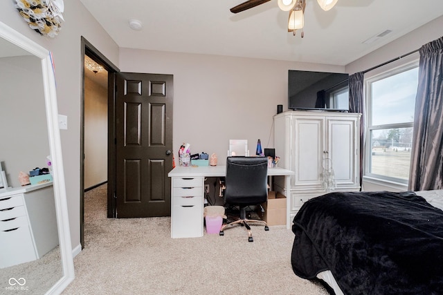 carpeted bedroom featuring visible vents and a ceiling fan