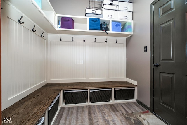 mudroom featuring baseboards and wood finished floors