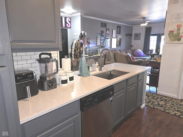 kitchen with a sink, ornamental molding, dishwasher, and gray cabinetry