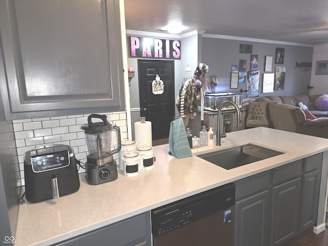 kitchen with a sink, ornamental molding, light countertops, and dishwasher