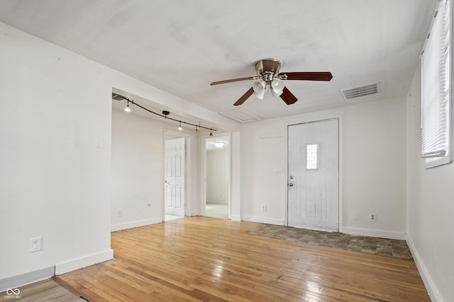 entrance foyer featuring baseboards, visible vents, ceiling fan, and hardwood / wood-style floors