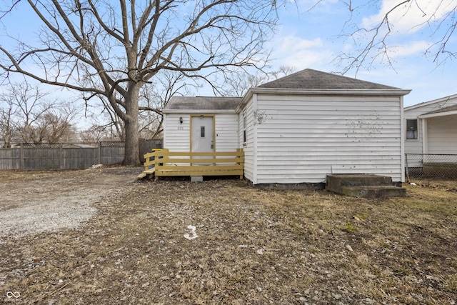 rear view of property with fence