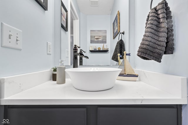 bathroom with visible vents, a textured ceiling, and vanity