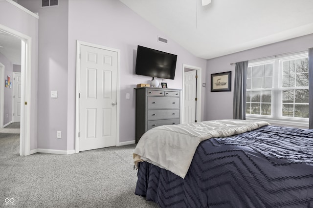 carpeted bedroom featuring vaulted ceiling, visible vents, and baseboards