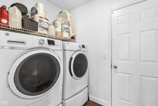 laundry room featuring laundry area, washing machine and clothes dryer, and baseboards