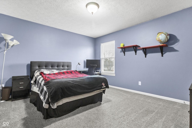 carpeted bedroom with a textured ceiling and baseboards