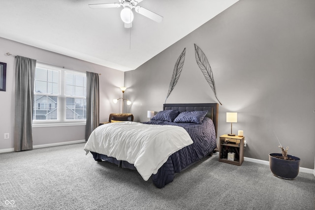 carpeted bedroom with ceiling fan and baseboards