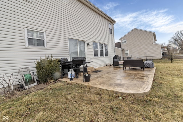 rear view of house featuring a yard and a patio