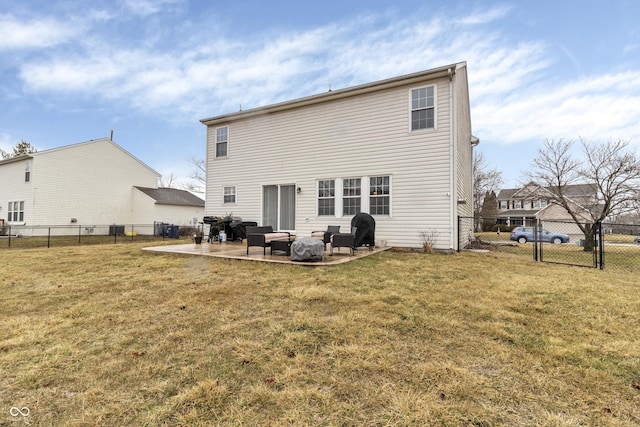 back of property with a patio area, a fenced backyard, and a lawn