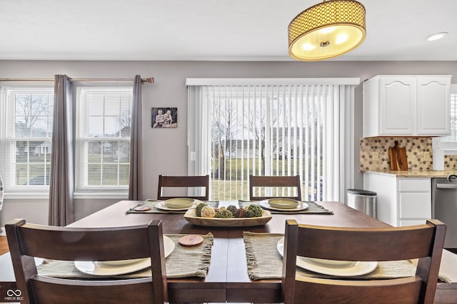 dining room with plenty of natural light and wood finished floors