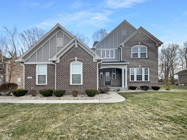 view of front of home featuring board and batten siding, brick siding, and a front lawn