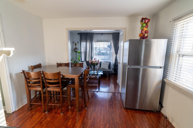 dining room featuring baseboards and wood finished floors