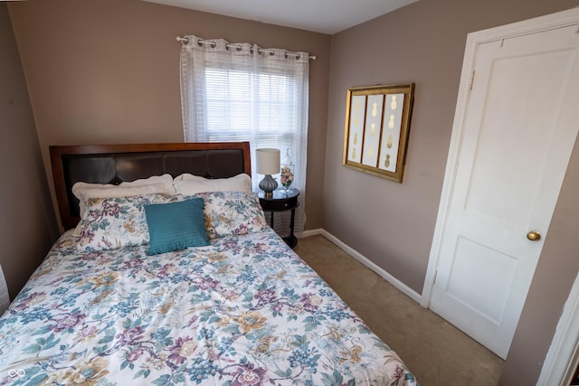 bedroom featuring carpet floors and baseboards