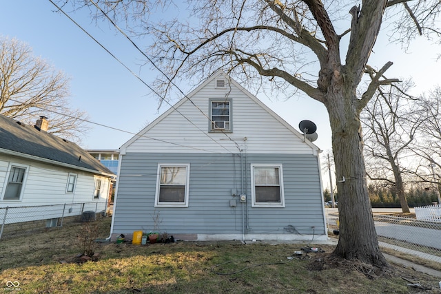 back of house featuring fence