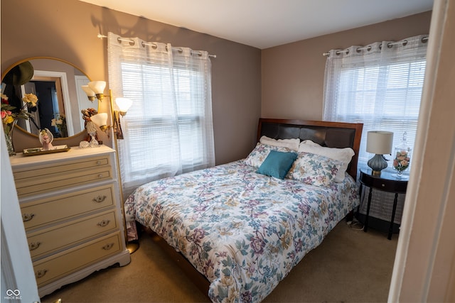 bedroom featuring light carpet and multiple windows