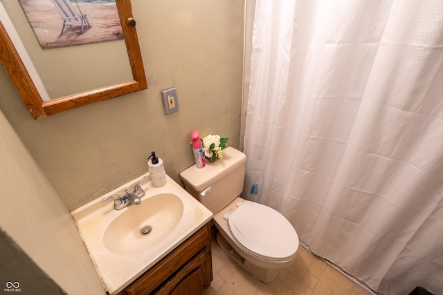 bathroom with curtained shower, vanity, toilet, and tile patterned floors