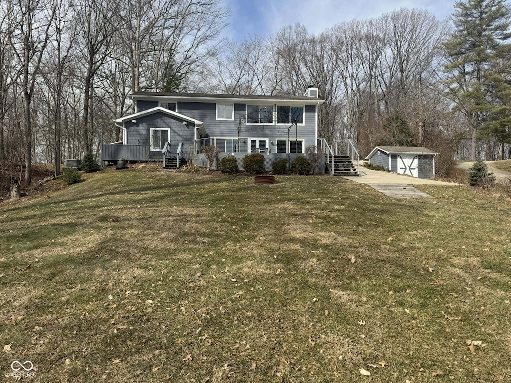 view of front of property with a garage, an outdoor structure, and a front yard