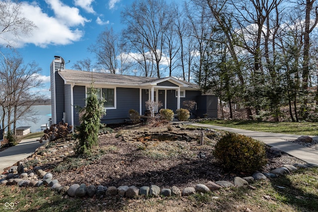 view of front of house with covered porch and a chimney