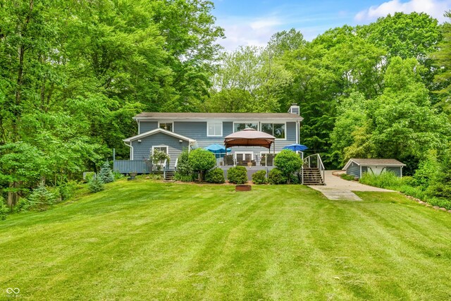 7600 N Blue Heron Dr, Unionville, IN 47468 - rear view of property featuring a gazebo, a deck, a chimney, and a lawn