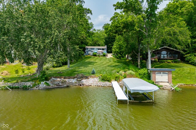 7600 N Blue Heron Dr, Unionville, IN 47468 - dock area with boat lift, a water view, and a lawn