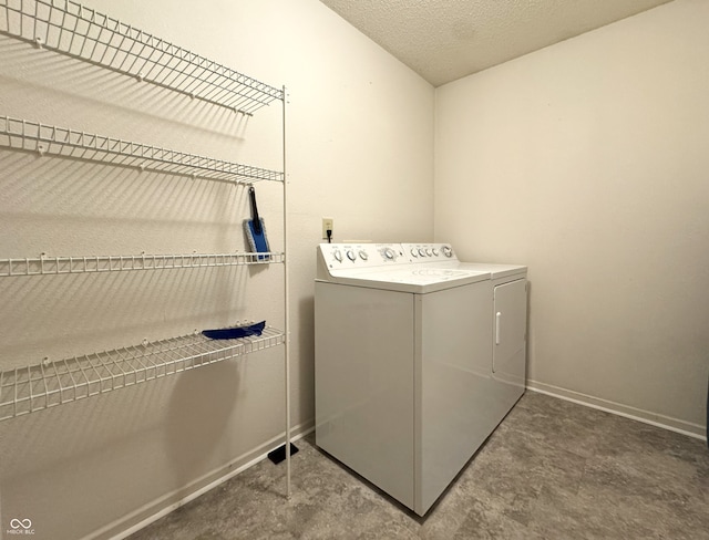 laundry room with washer and dryer, laundry area, a textured ceiling, and baseboards