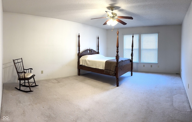 carpeted bedroom with baseboards, a ceiling fan, and a textured ceiling