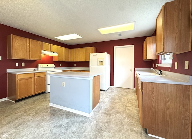 kitchen with white appliances, under cabinet range hood, and light countertops