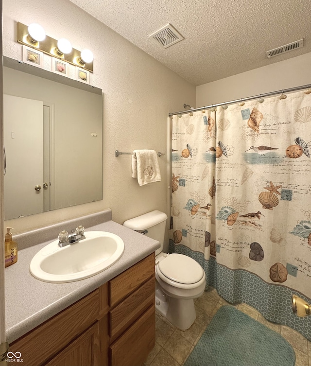 bathroom featuring visible vents, a textured ceiling, toilet, and vanity