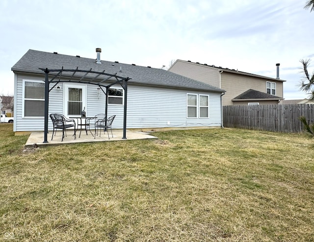 rear view of house with roof with shingles, a yard, a patio, fence, and a pergola