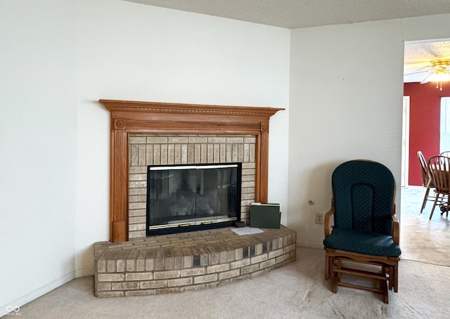 sitting room featuring carpet floors, a fireplace, baseboards, and a textured ceiling