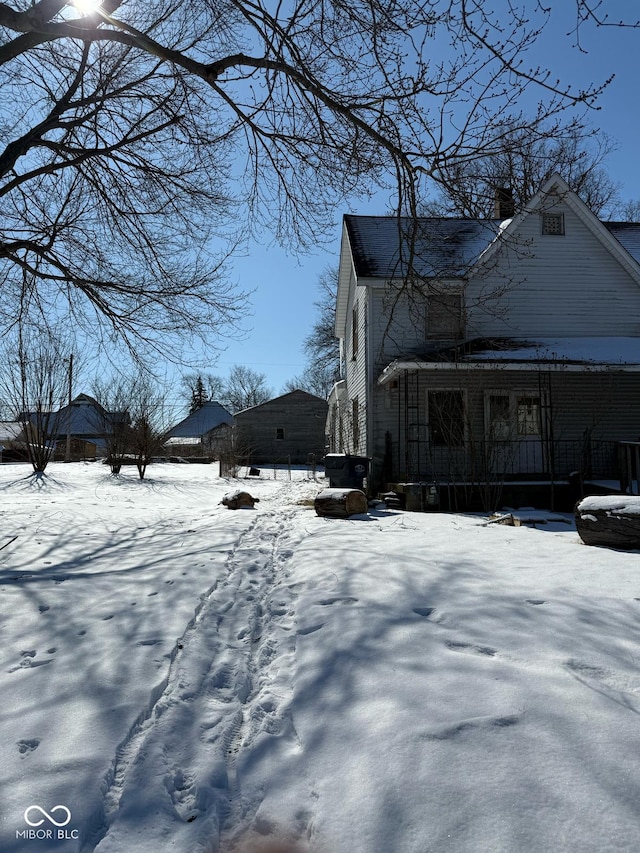 snow covered property featuring a porch