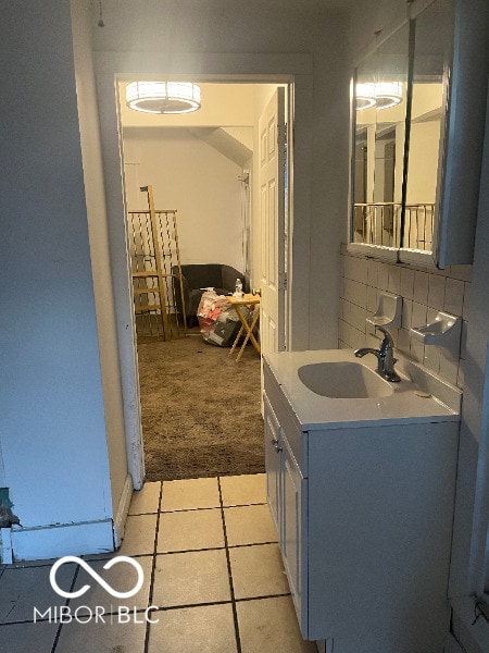 bathroom with vanity, decorative backsplash, and tile patterned floors