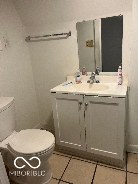 bathroom featuring vanity, toilet, and tile patterned floors