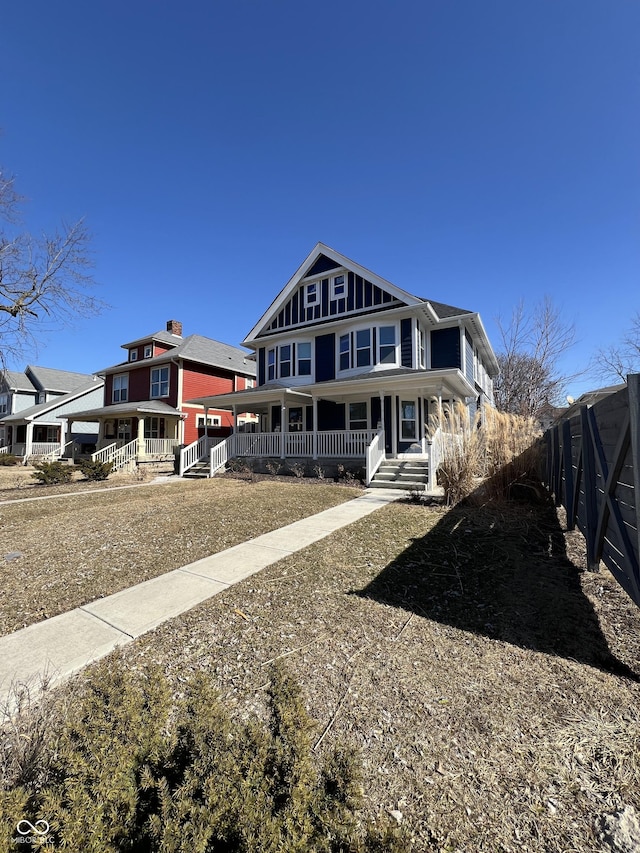 view of front of property with a porch and fence