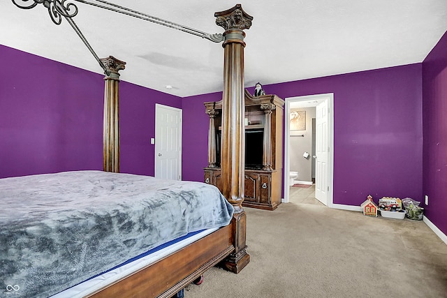 bedroom featuring carpet floors, ensuite bath, and baseboards