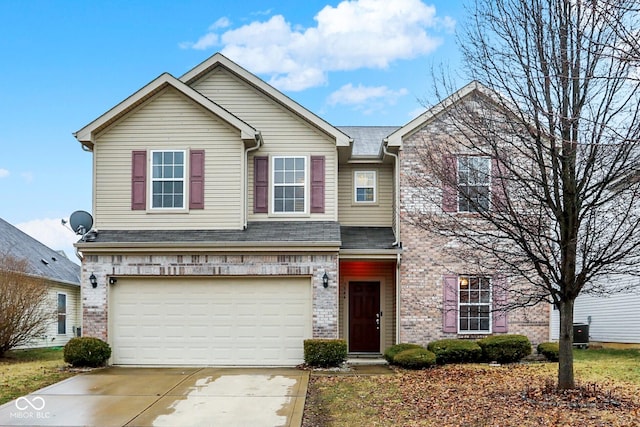 view of front of house featuring a garage, driveway, and brick siding