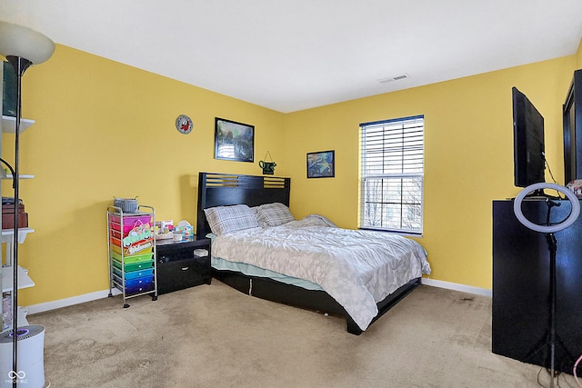 carpeted bedroom with visible vents and baseboards