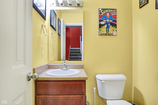 half bathroom with vanity and toilet