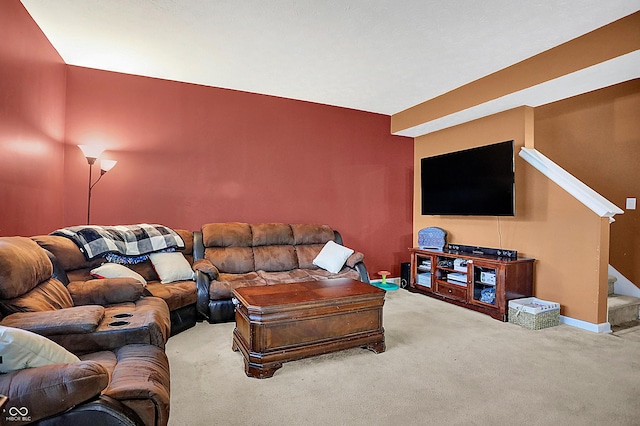 carpeted living area featuring baseboards and stairs