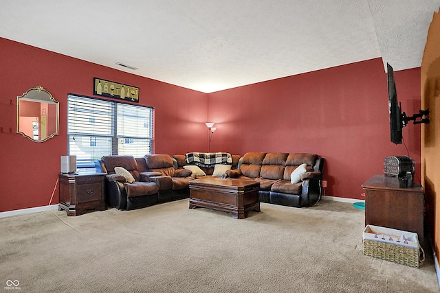 living area with carpet floors, visible vents, a textured ceiling, and baseboards