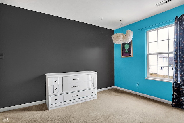 empty room with light carpet, a wealth of natural light, and baseboards