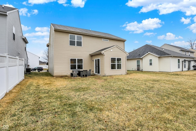 back of house featuring a lawn, fence, and central air condition unit