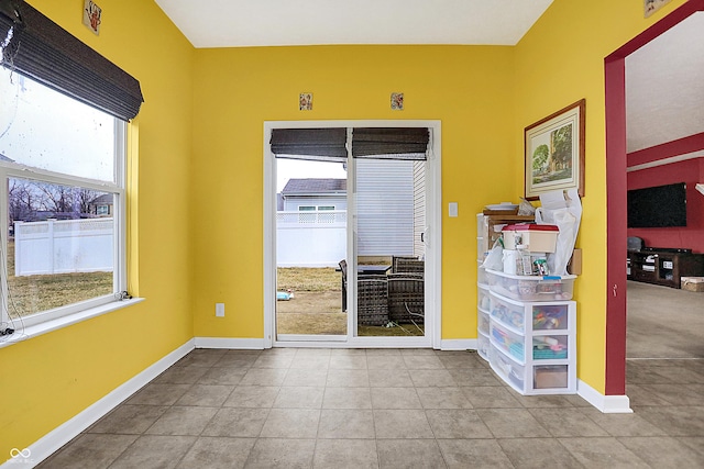 interior space featuring tile patterned flooring and baseboards