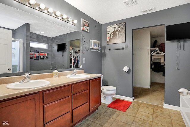 full bathroom featuring a spacious closet, a sink, and visible vents