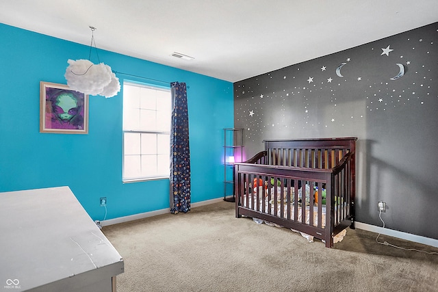 carpeted bedroom with visible vents, a crib, and baseboards